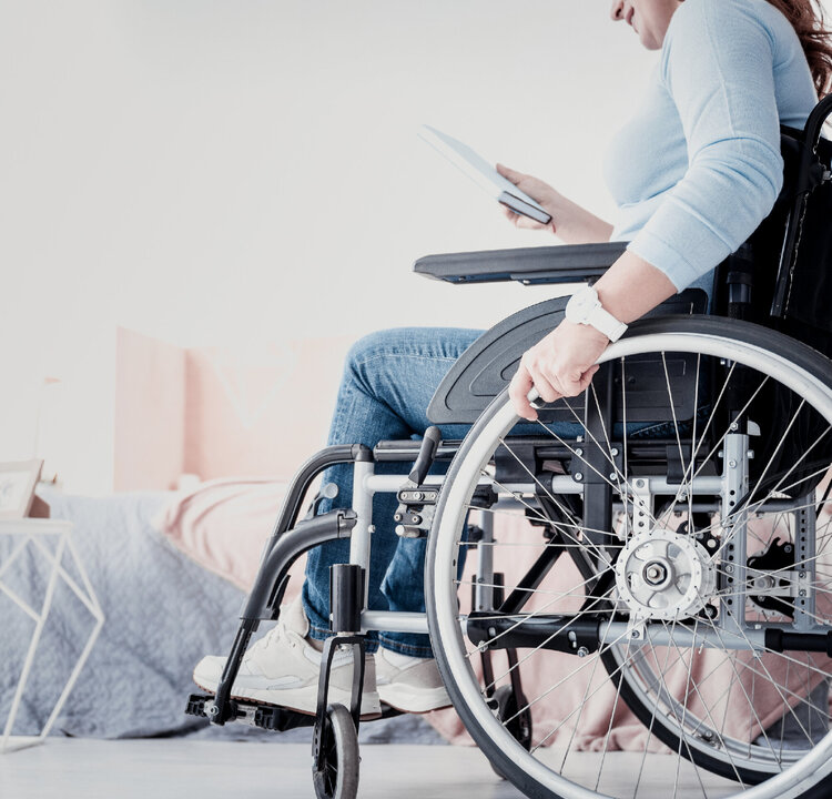 Disabled woman in a wheelchair holding her book