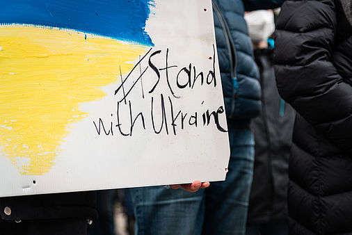 Holzschild mit der ukrainischen Flagge und der Schrift #stand with ukraine